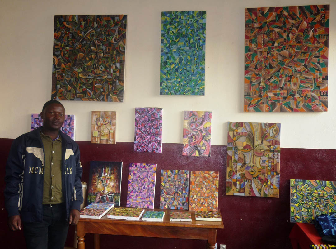 Angu Walters with his paintings